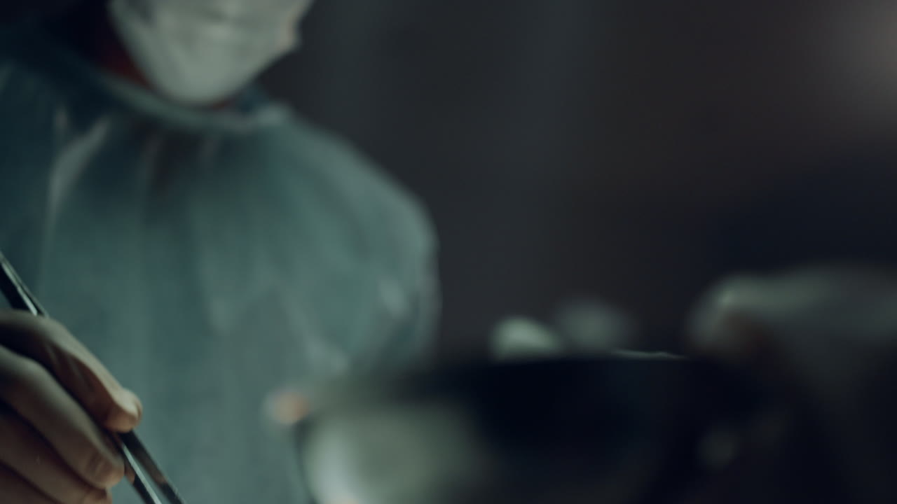 Confident surgeon operating patient in dark hospital emergency ward portrait.