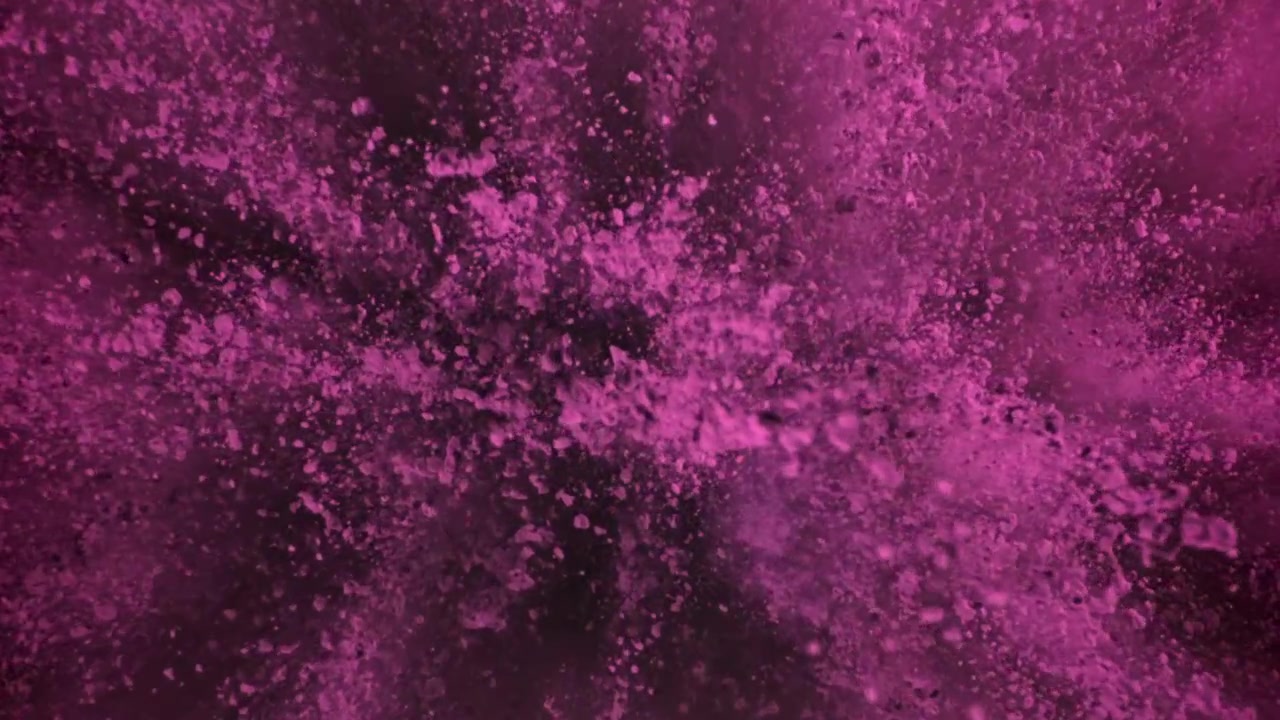 Levende lyserødt støv brister og spredes i slowmotion