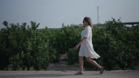 woman walking in a citrus grove