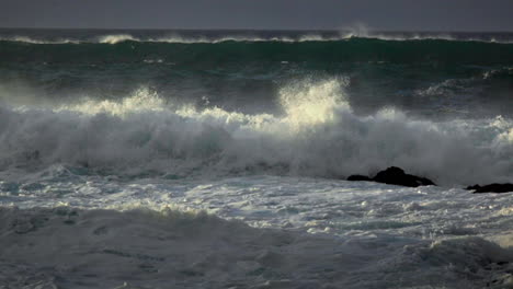 waves roll into a beach following a big storm in slow motion 3