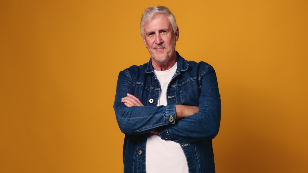 Portrait of a smiling senior man in denim jacket