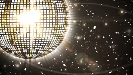 Animation-of-rotating-mirror-disco-ball-over-falling-confetti,-lens-flares-against-black-background