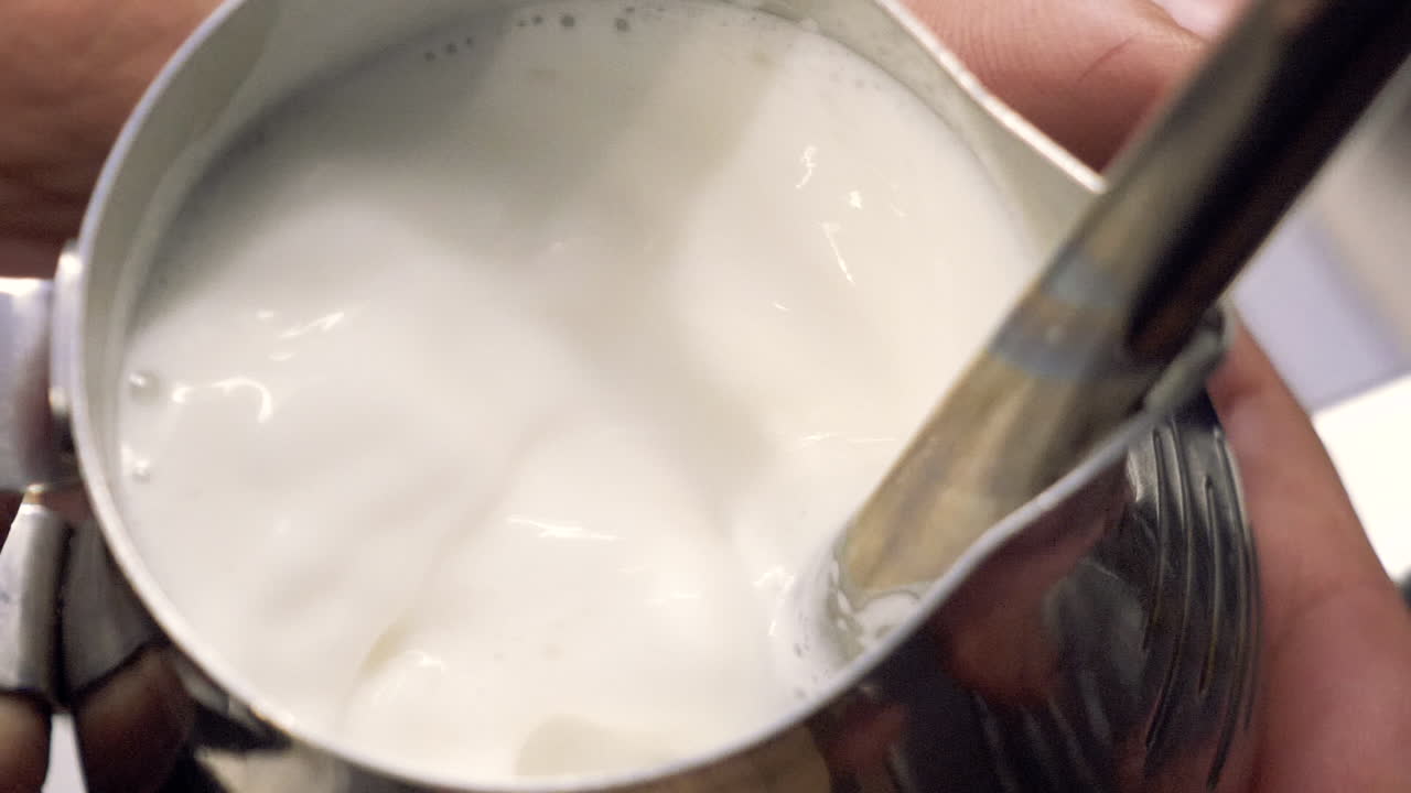 leche al vapor de barista con máquina de espresso para latte o capuchino