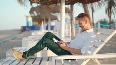 businessman taking notes on beach