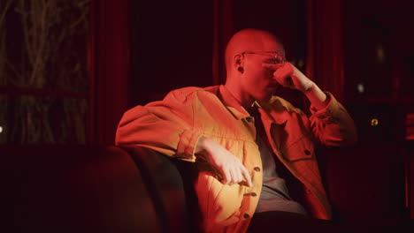 person sitting on a couch in red light