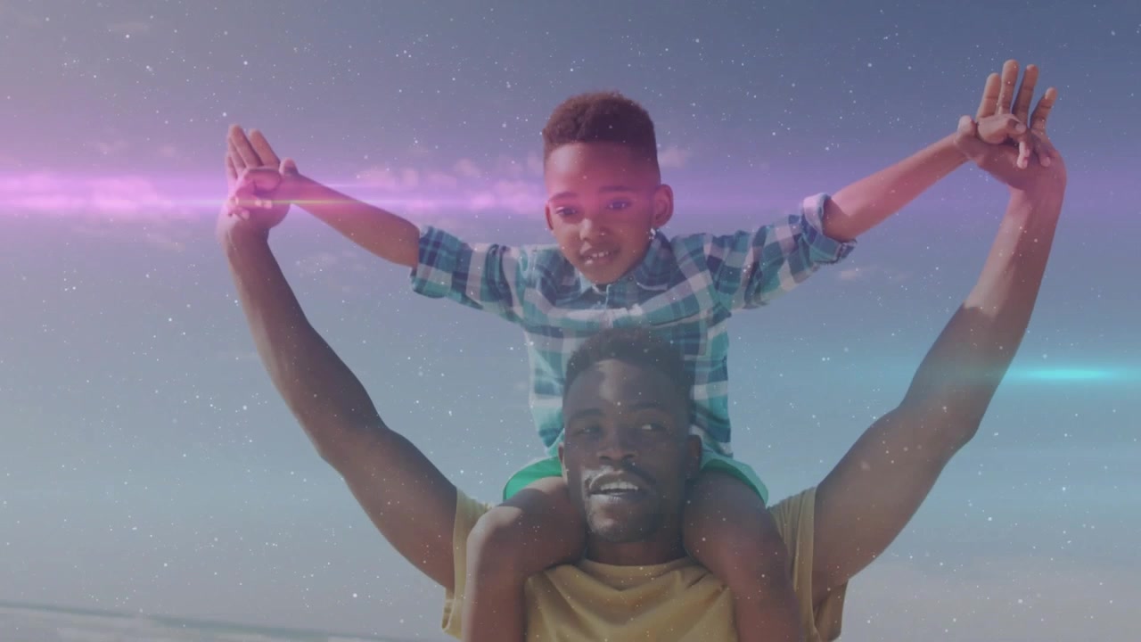 Papa portant un enfant sur ses épaules, l'enfant tendant les bras vers le haut, provoquant le soulèvement des bras pour une publicité de voyage avec un balayage lumineux