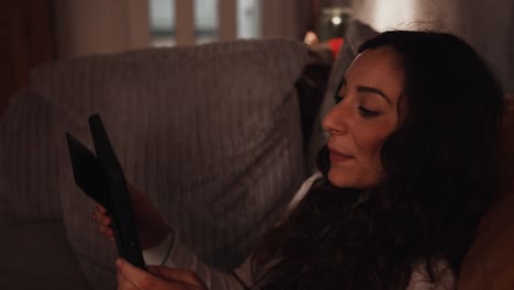 young italian woman waves goodbye to her tablet device from a video call