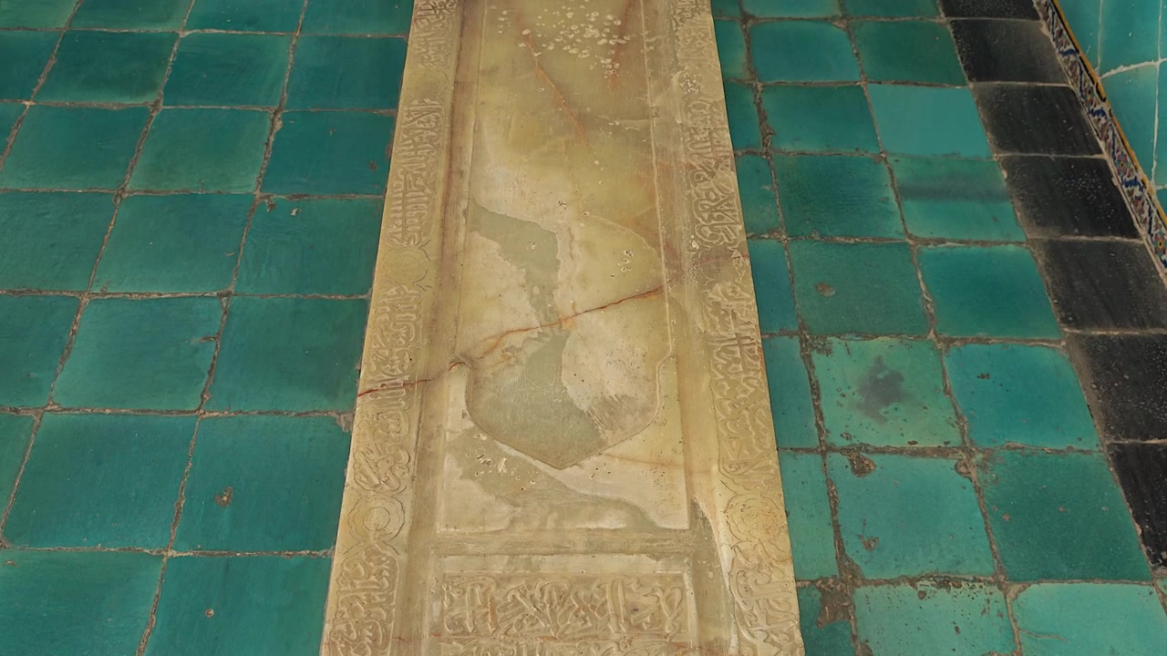 Ancient Stone Sarcophagus with Arabic Calligraphy in a Tiled Chamber