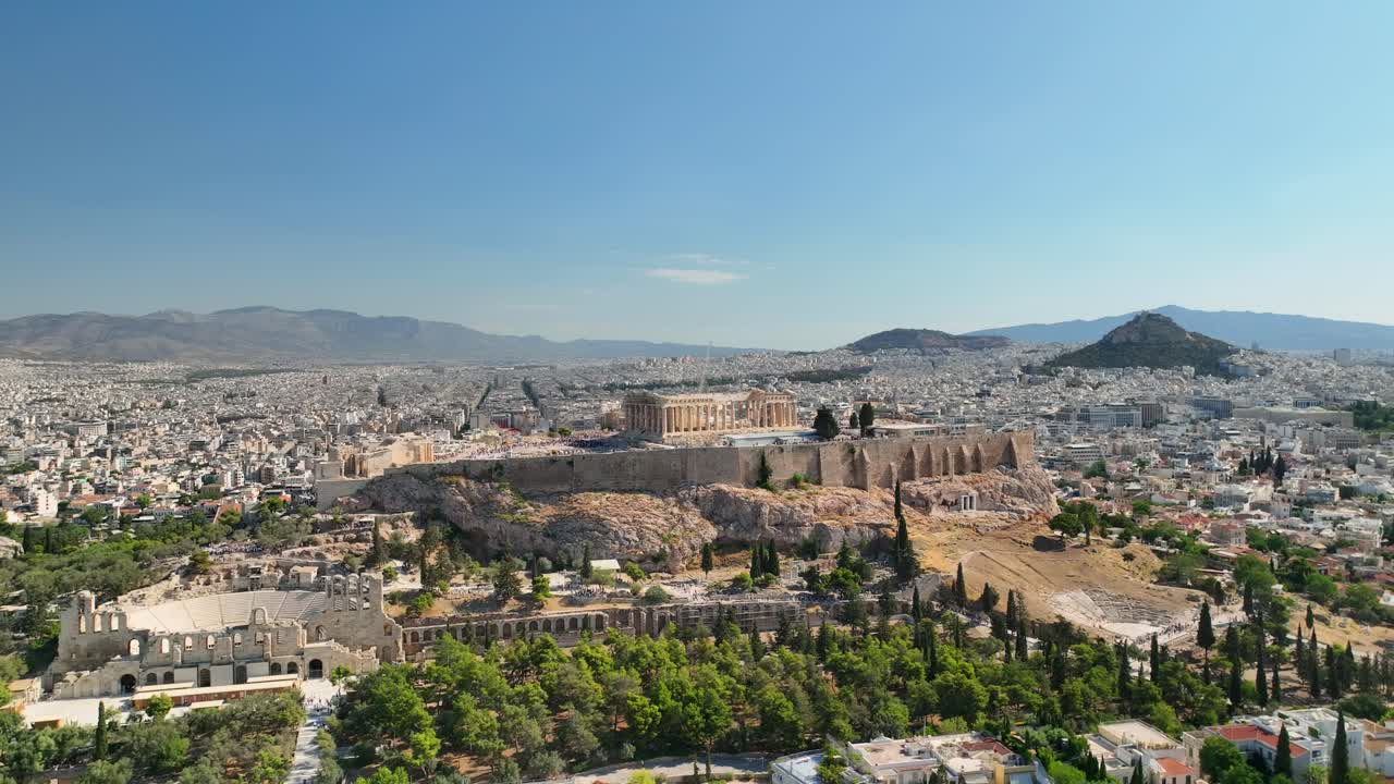 Ancient Acropolis hill in UHD, captured by drone in sunny conditions, featuring iconic Greek structures and panoramic urban surroundings.