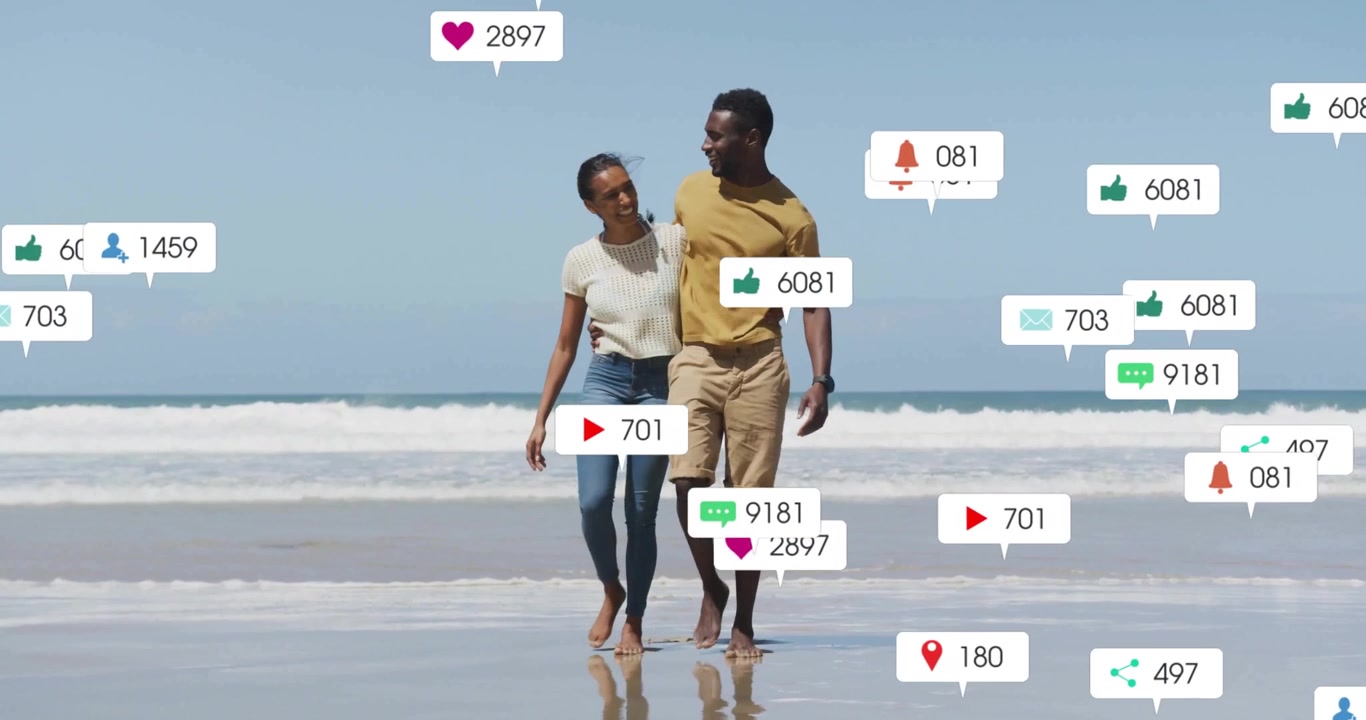 Couple entering frame walking arm in arm along beach showing social media icons growing then fading