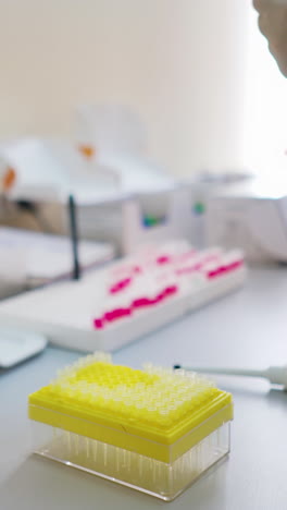 test tubes on the table in the laboratory. medical worker in sterile gloves conducts experiments with samples in clinic. healthcare concept. vertical video