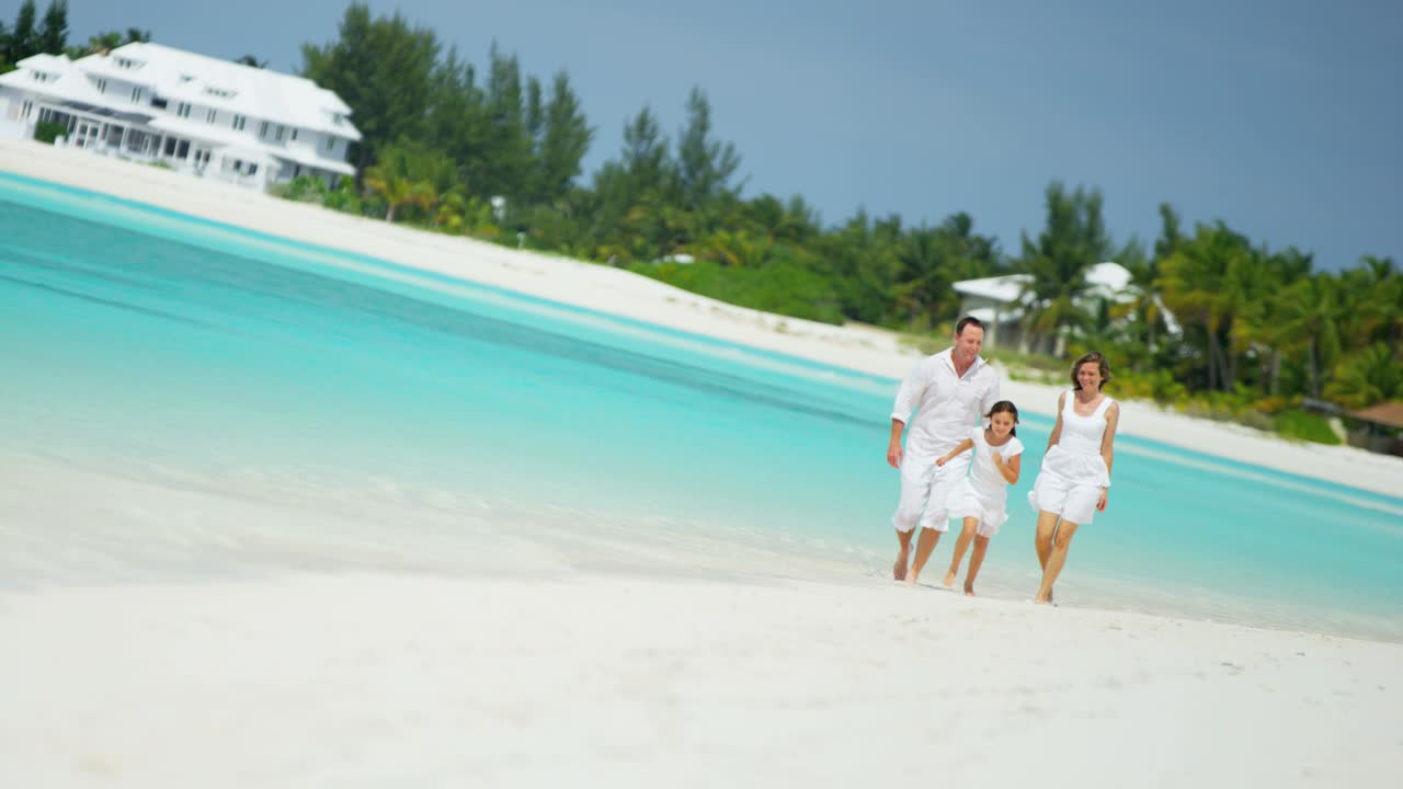 Caucasian parents with their young daughter on beach