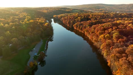 aerial reveal of calm lake among rural appalachian countryside