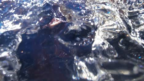 clear mountain stream waterfall water shot from underwater then revealing a small waterfall