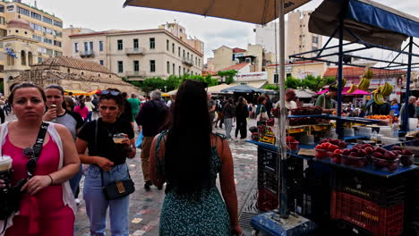 a bustling street market with people and produce stalls