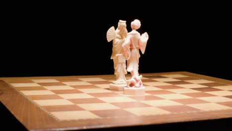 chess pieces, king and queen head to head in the center of chessboard, game concept