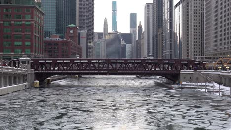 subway passing over frozen river downtown city view