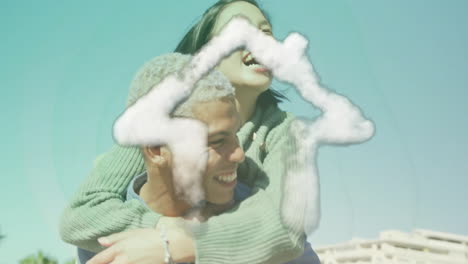 animation of cloud house icon over happy biracial man carrying his girlfriend piggyback