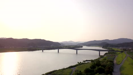 drone aerial view of shikoku, nakamura during sunset with soft light. countryside of japan, new shimanto river bridge..