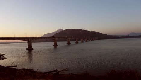 the grand friendship bridge spans the mekong river, presenting a picturesque vista