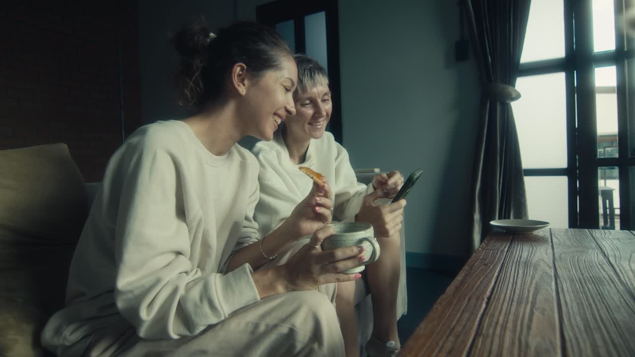 Two Women Enjoying Coffee and Toast at Home