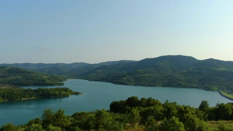 lake butoniga water reservoir dam in croatia wide angle panorama forward approach, aerial drone flyover shot