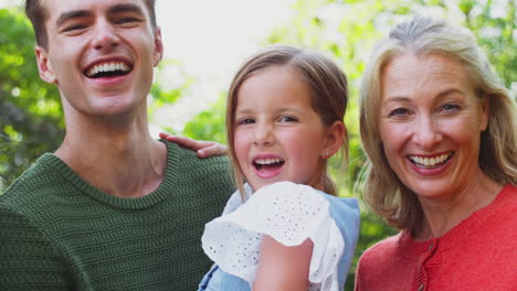 portrait of multi-generation family enjoying walk in countryside together
