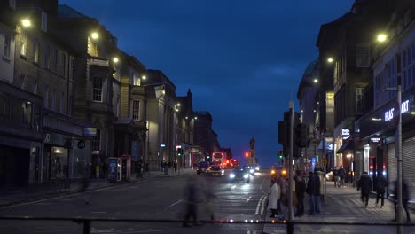 4k stylised timelapse of a busy road intersection at dusk in edinburgh in scotland in united kingdom with cars and people passing by