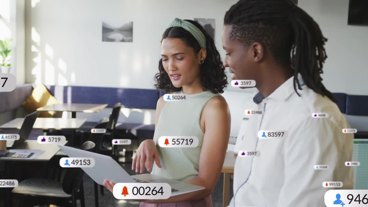 Woman pointing and speaking, man leaning in, badges growing around laptop, boosting marketing