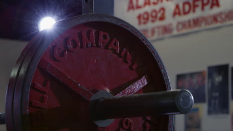 plates being added to weightlifting bar