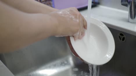 washing dishes in kitchen sink