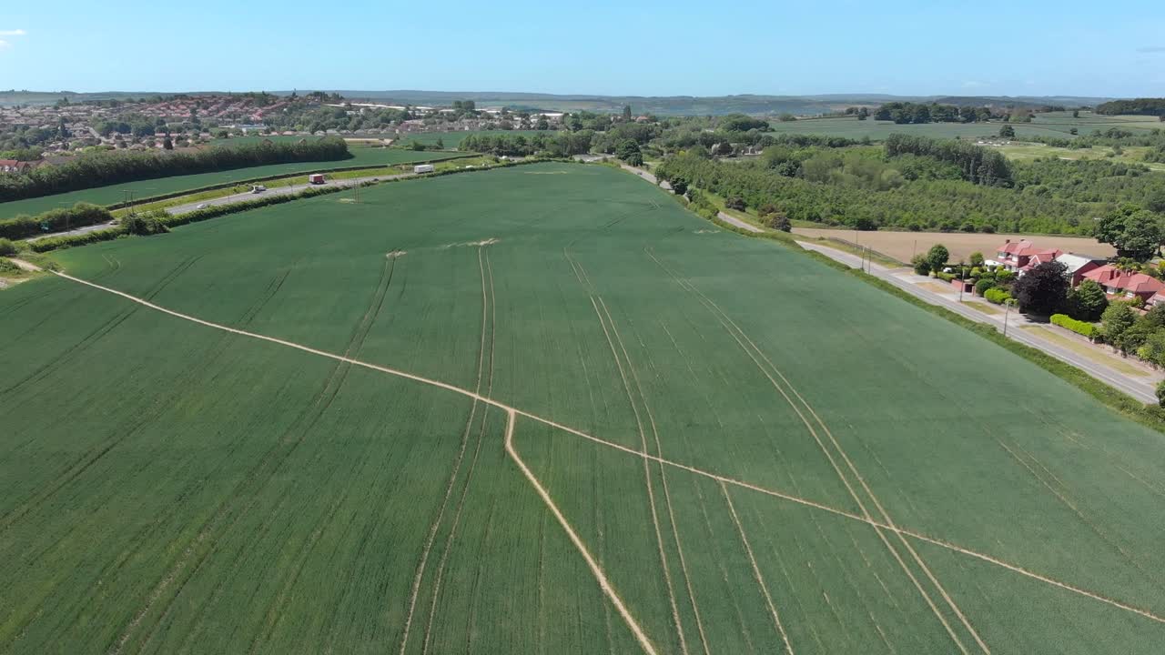 Drone reverse shot over crop field in summer, Barnsley England