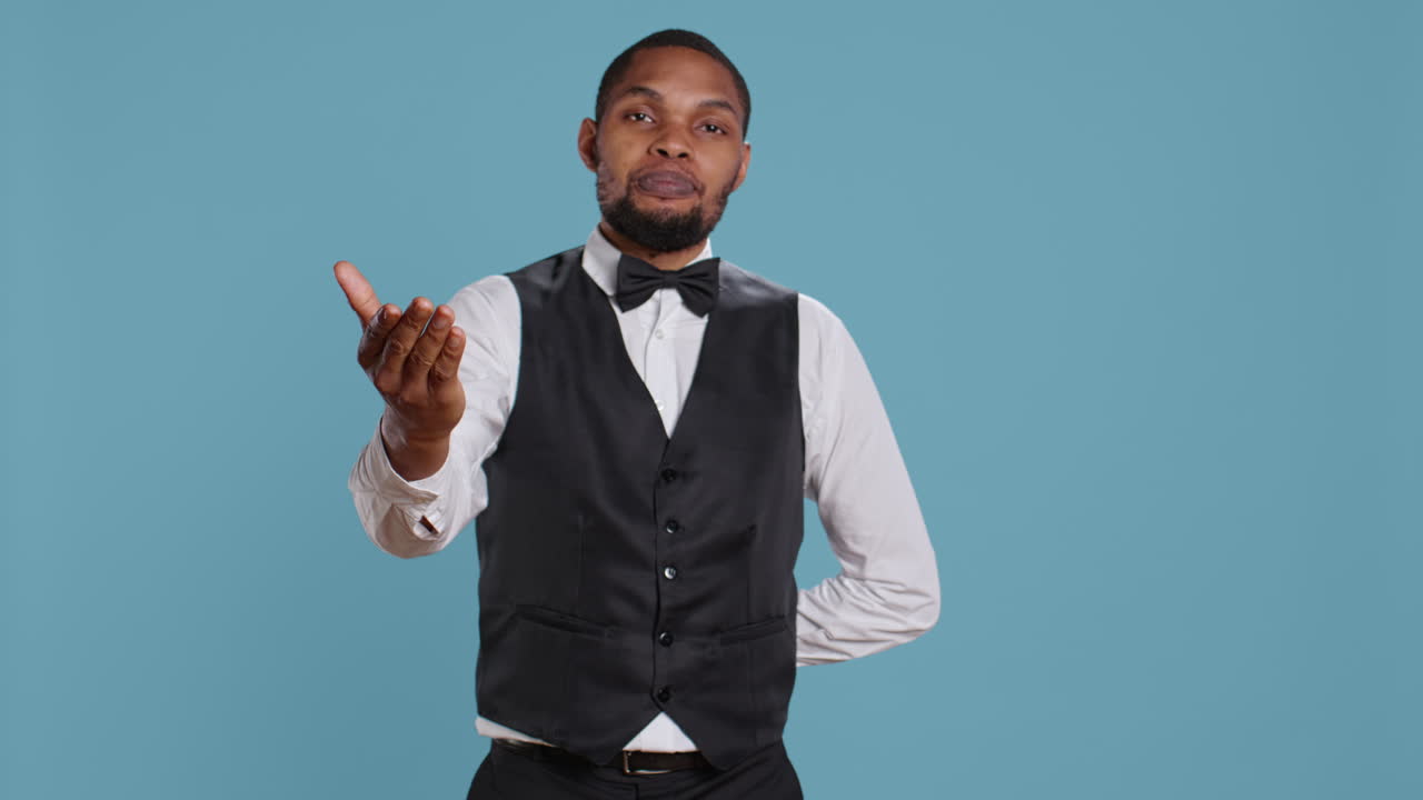 Friendly doorkeeper at five star hotel greeting guests and offering his services