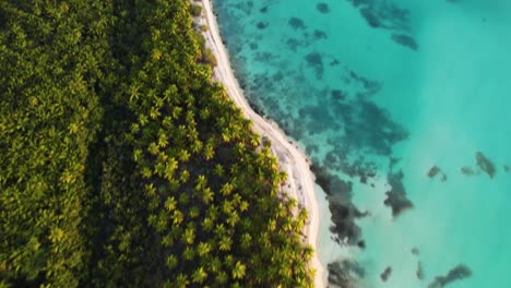 Aerial-view-of-tropical-beaches-of-Punta-Cana,-golden-hour-in-Dominican-republic---tilt,-drone-shot