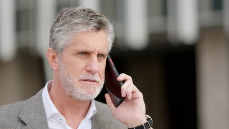mature man engaged in phone call