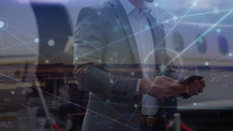 animation of network of connections and cityscape over caucasian businessman using smartphone
