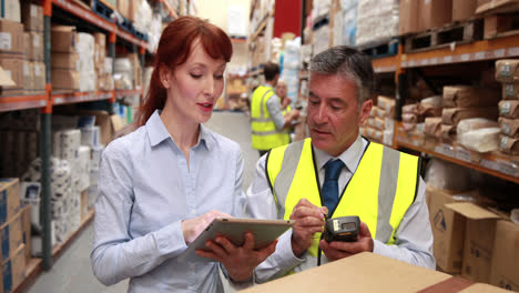 warehouse manager and boss using a touchscreen device