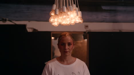 woman in a cafe with a unique light fixture
