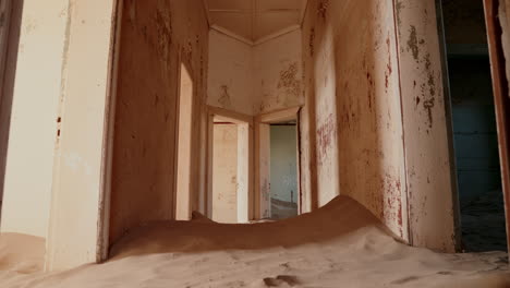 abandoned house filled with sand in a desert