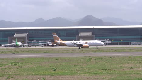 the atmosphere of the runway at yogyakarta international airport, a commercial plane is seen about to take off.