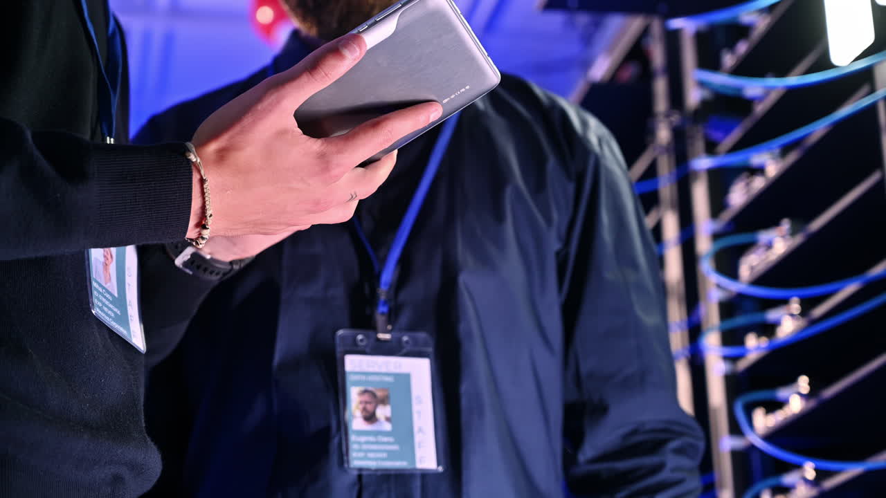 Close up of two men analysing data in a server room