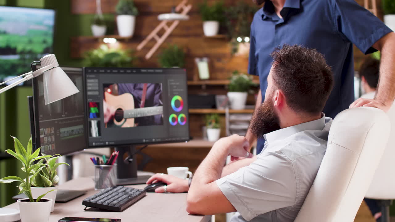 Man editing video at his office