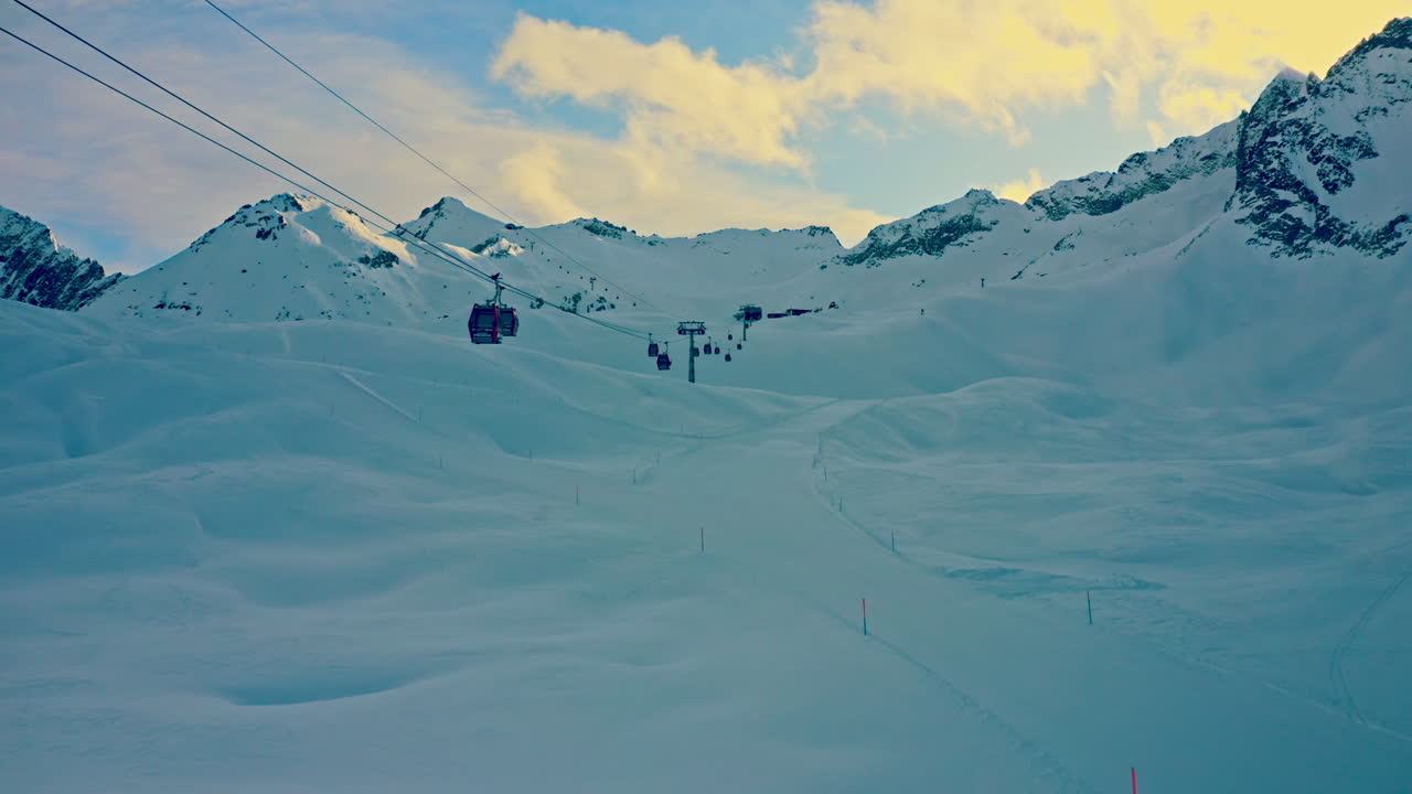 Aerial view of Ski Elevator in Mountain Resort. 
Drone Shot of People transporting on Ski Lift on Snowy Mountain Peak