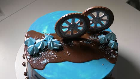 blue children's cake with car wheels