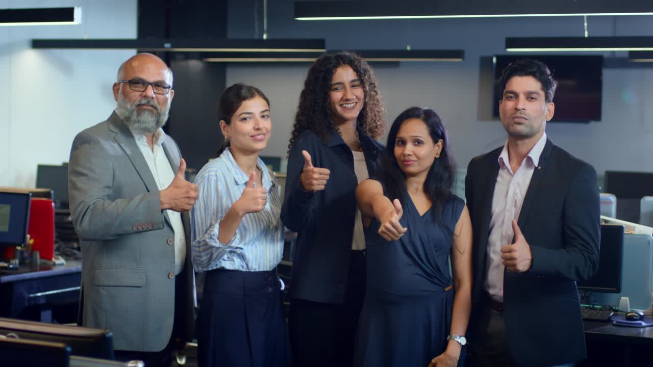 Group of ambitious Indian mixed Gender corporate office employees with thumbs up