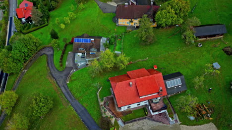 aerial modern houses with solar panels installed on roof in rural village nature