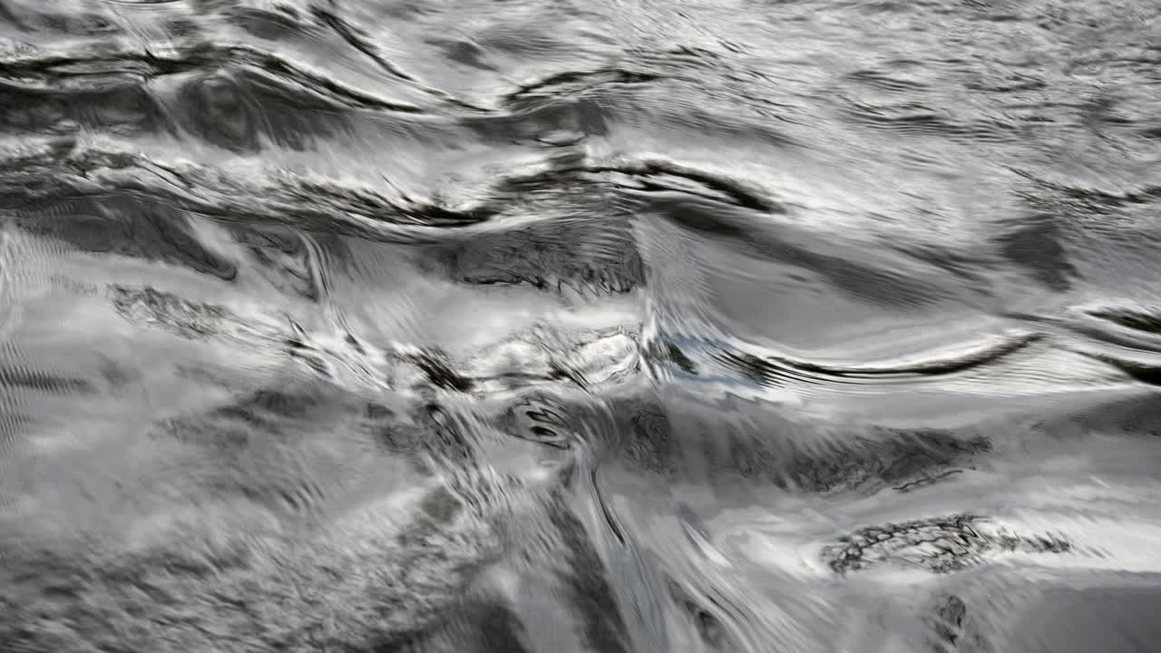A closeup of fast flowing water in the River Arrow, Warwickshire, UK on a cold autumn day