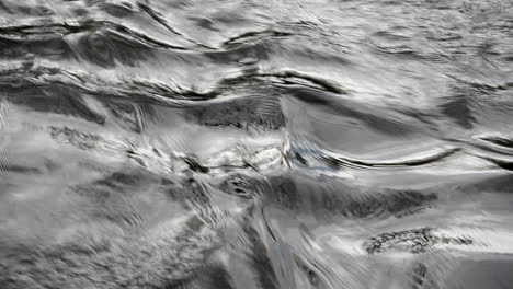 A-closeup-of-fast-flowing-water-in-the-River-Arrow,-Warwickshire,-UK-on-a-cold-autumn-day