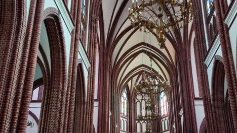 inside view of the majestic cathedral, showing the tall arches and chandeliers