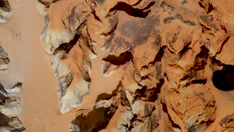 aerial view in the middle of the cliffs, in a sunny day, morro branco, ceara